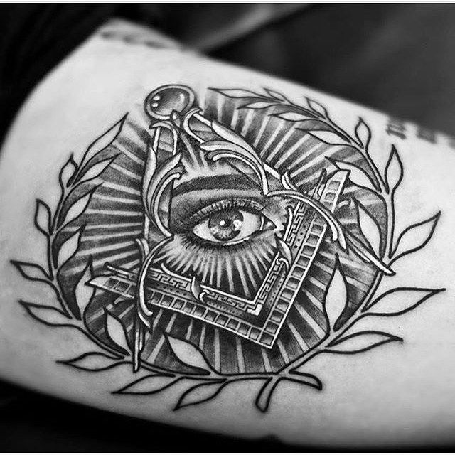 a black and white tattoo with an all seeing eye