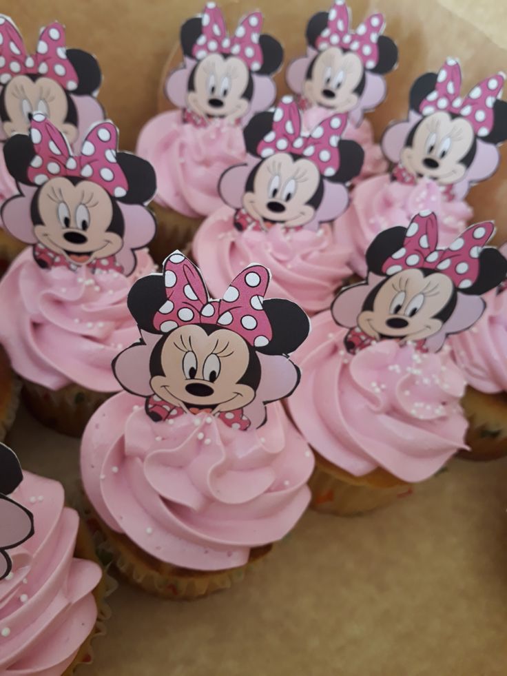 cupcakes with pink frosting and minnie mouse decorations