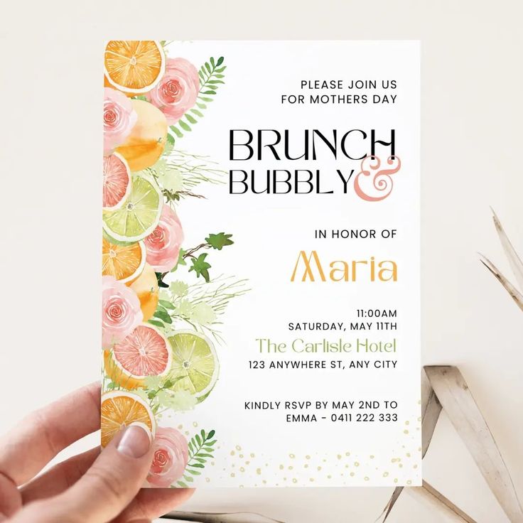 a person holding up a brunch and bubbly birthday party card with citrus slices on it