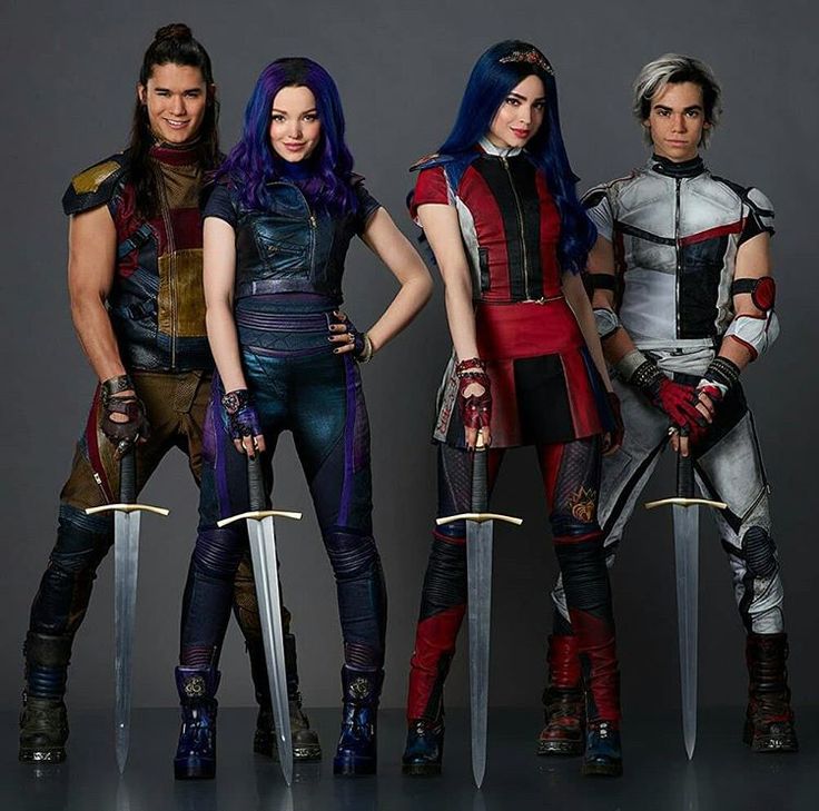 four people in costume standing next to each other holding swords and posing for the camera