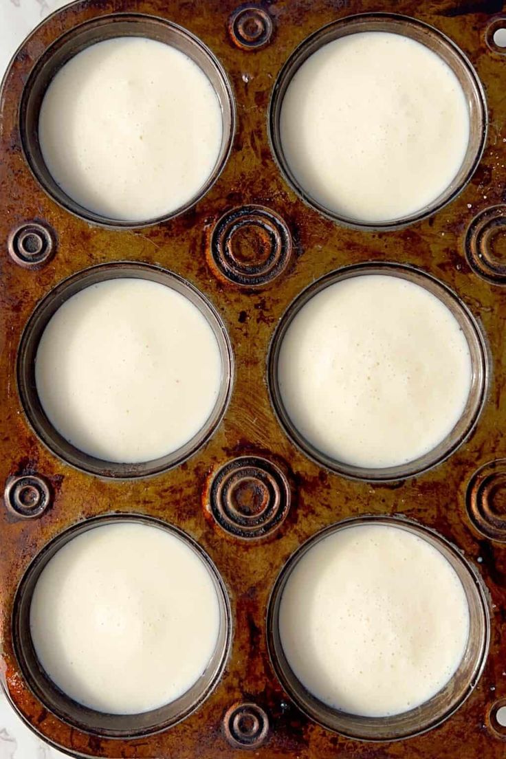 an old metal tray filled with lots of white liquid