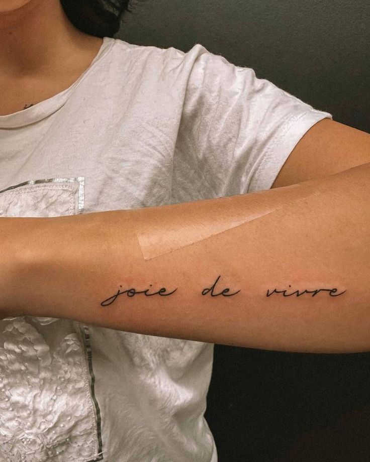 a woman's arm with the words joie de nive written on it