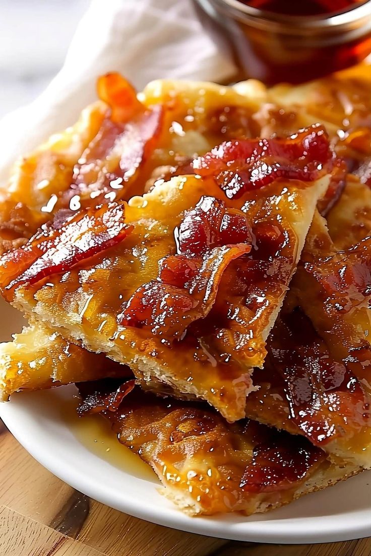 some food is sitting on a white plate with sauce and ketchup in the background