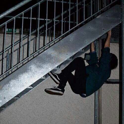 a skateboarder is going down the metal handrail