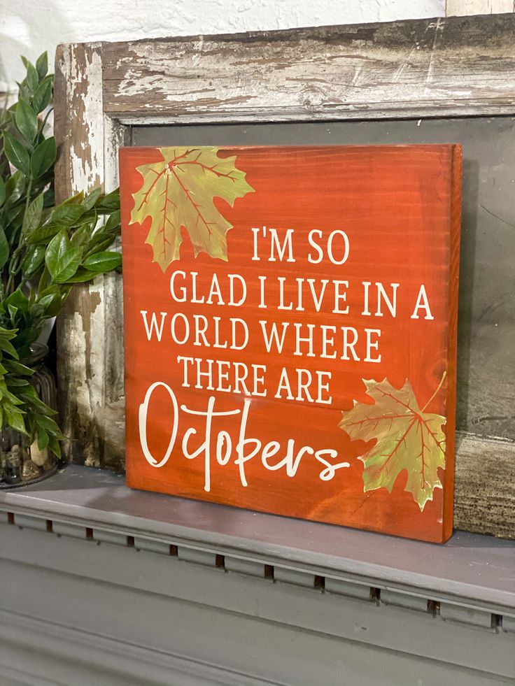 a wooden sign that says i'm so glad i live in a world where there are others