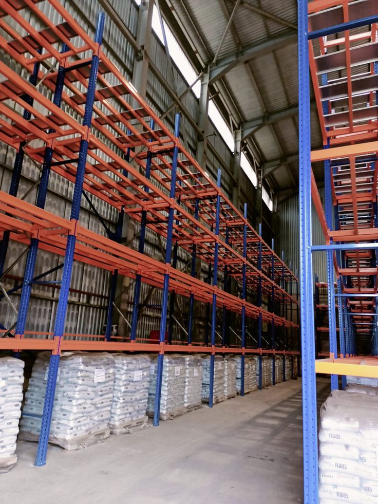 the warehouse is filled with lots of shelves and pallets for goods to be shipped