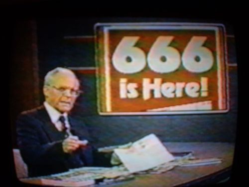 an old man sitting at a desk in front of a sign that says 666 is here