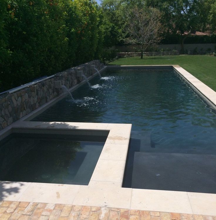 an empty swimming pool in the middle of a yard