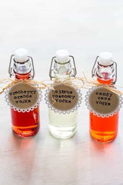 three small bottles filled with liquid sitting on top of a table