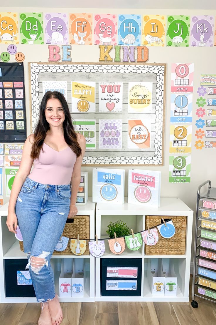 a woman standing in front of a wall with lots of cards and letters on it