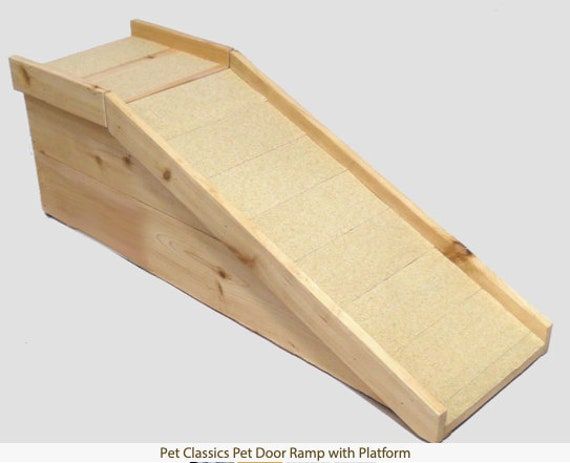 a wooden pet ramp is shown with the bottom section removed from it's sides