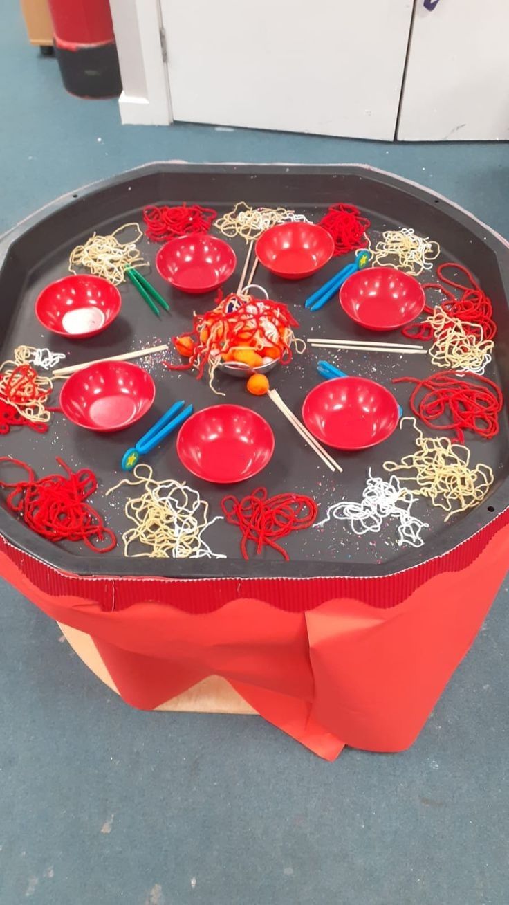 a table that has some red bowls on it