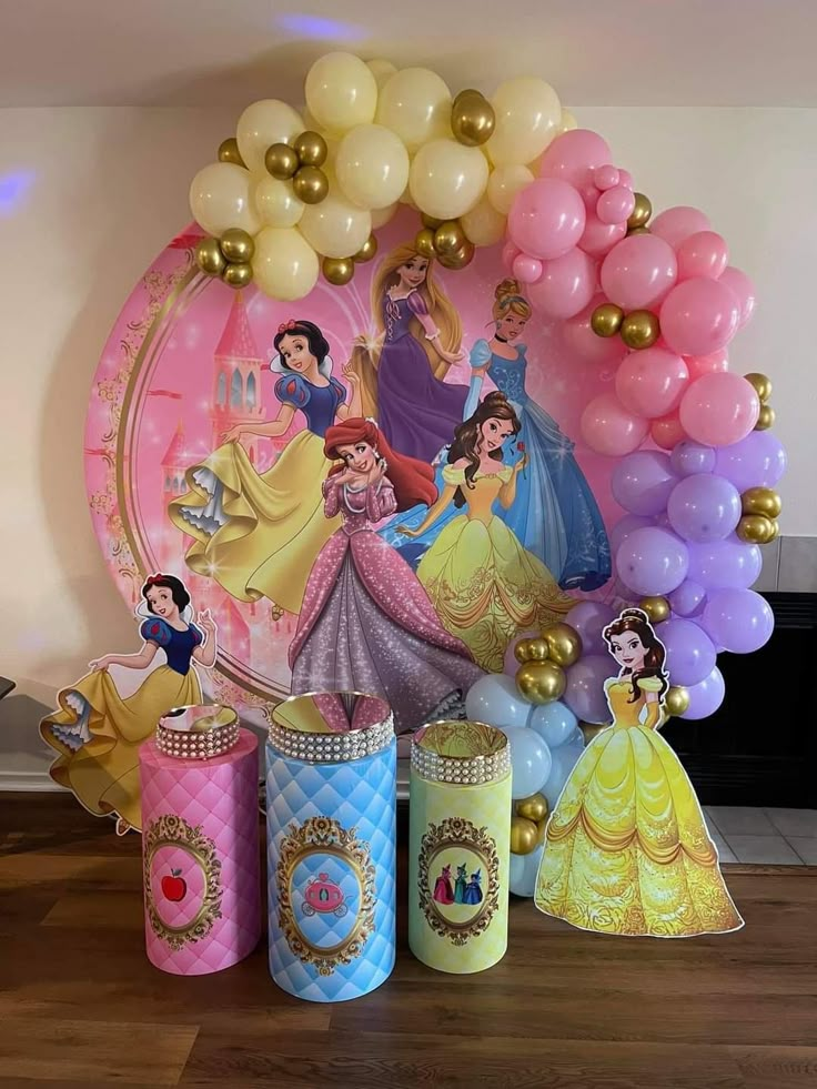 a table with balloons and princesses on it