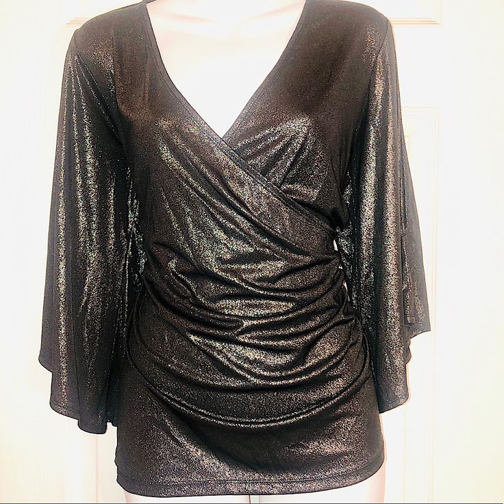 New! Never Been Worn! Gorgeous Gunmetal Gray Shimmery Top With Cold Shoulders.V Neck Blouse.Blouse Gathers On The Side So You Actually Put The Blouse On Over Your Head. Wonderful To Wear To A Holiday Event Or Just With Jeans. 92% Polyester 8% Elastane Metallic Fitted V-neck Top, Shimmer V-neck Top For Evening, Metallic Shimmer Blouse For Party, Evening Shimmer V-neck Top, Elegant Shiny Party Tops, Metallic Stretch Elegant Tops, Elegant Metallic Stretch Top, Metallic Shimmer Tops For Holidays, Metallic Shimmer Tops For Holiday