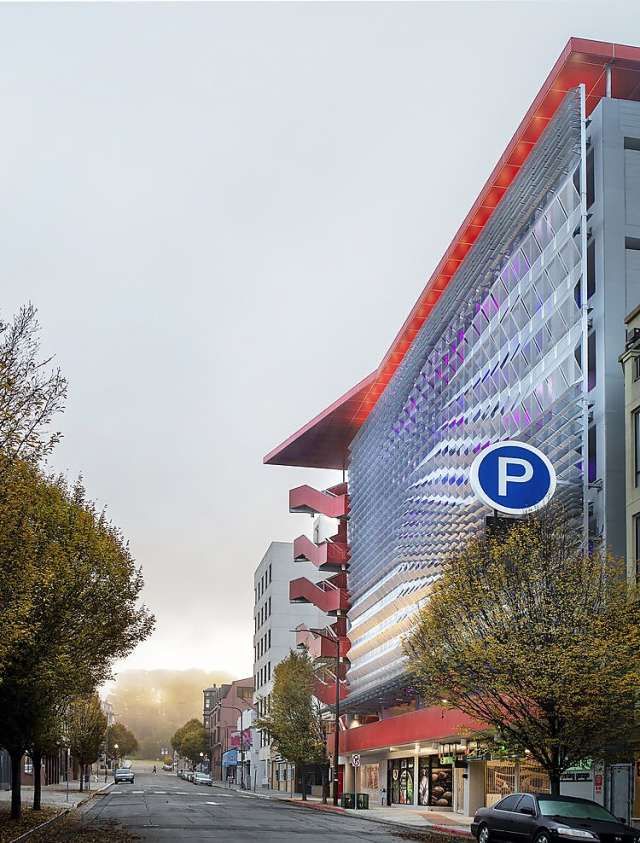 an empty street in front of a building with a parking sign on it's side