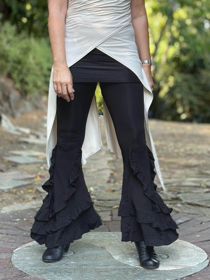 Flare Ruffle Pant Black Our Flare Ruffle Pants feature wide flares in a stretchy cotton jersey. They fit like leggings and have sassy tiered ruffles at the bottom. The fold-over waistband doubles as a skirt. These are our favorite dance pants! Size Suggestions: S/M: 4-8, inseam 32" M/L: 8-12, inseam 33" Learn MoreRead more information about our plant-based fabrics made in small batches and how to care for them to increase longevity. Learn more here. Ribbon Pants, Ruffled Pants, Bamboo Leggings, Ruched Pants, Summer Holiday Outfits, Cropped Flare Pants, Moto Pants, Dance Pants, Ruffle Pants