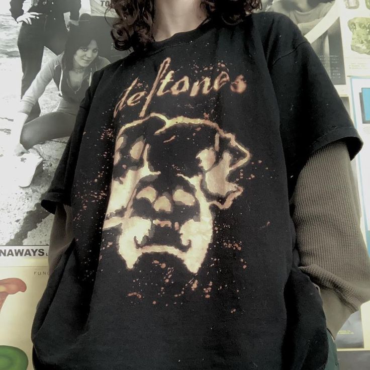 a woman wearing a black shirt with an image of a lion on it