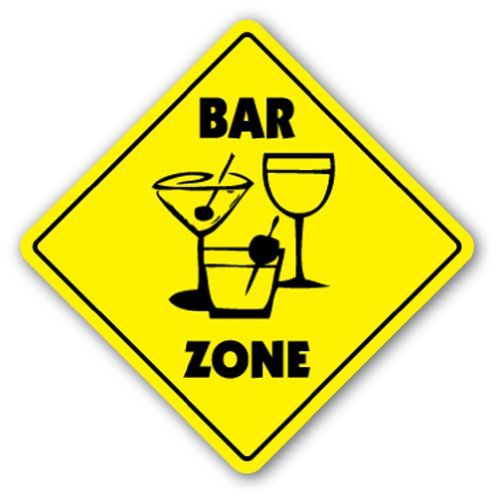 a yellow sign that says bar zone with two martini glasses on the bottom and an apple in the middle