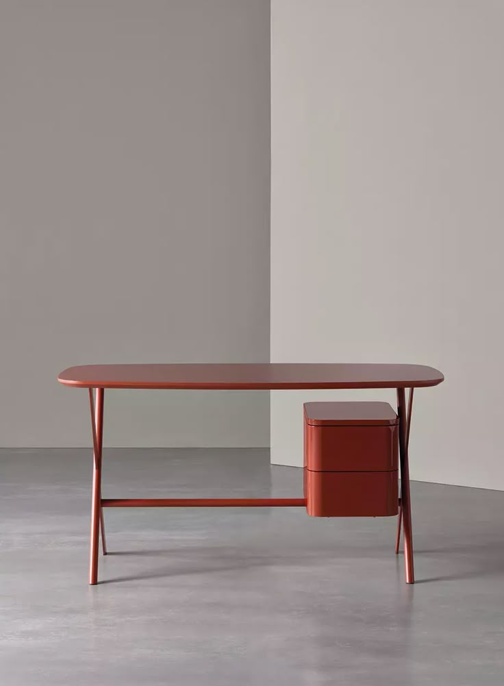 an orange table with two drawers on each side and a white wall in the background