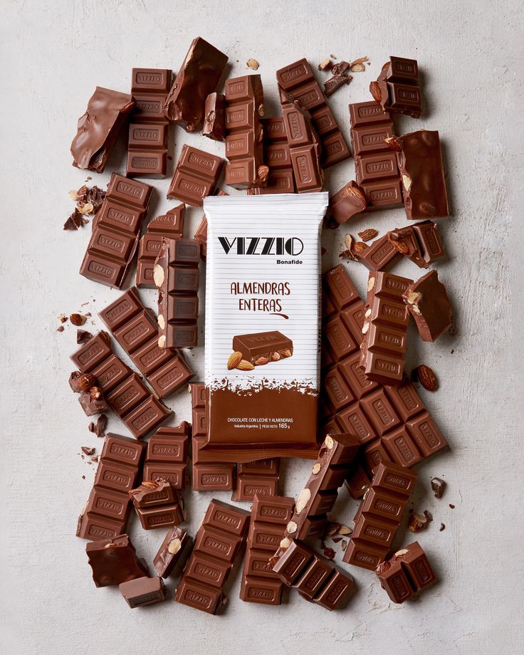 a pile of chocolate pieces sitting on top of a white table next to each other