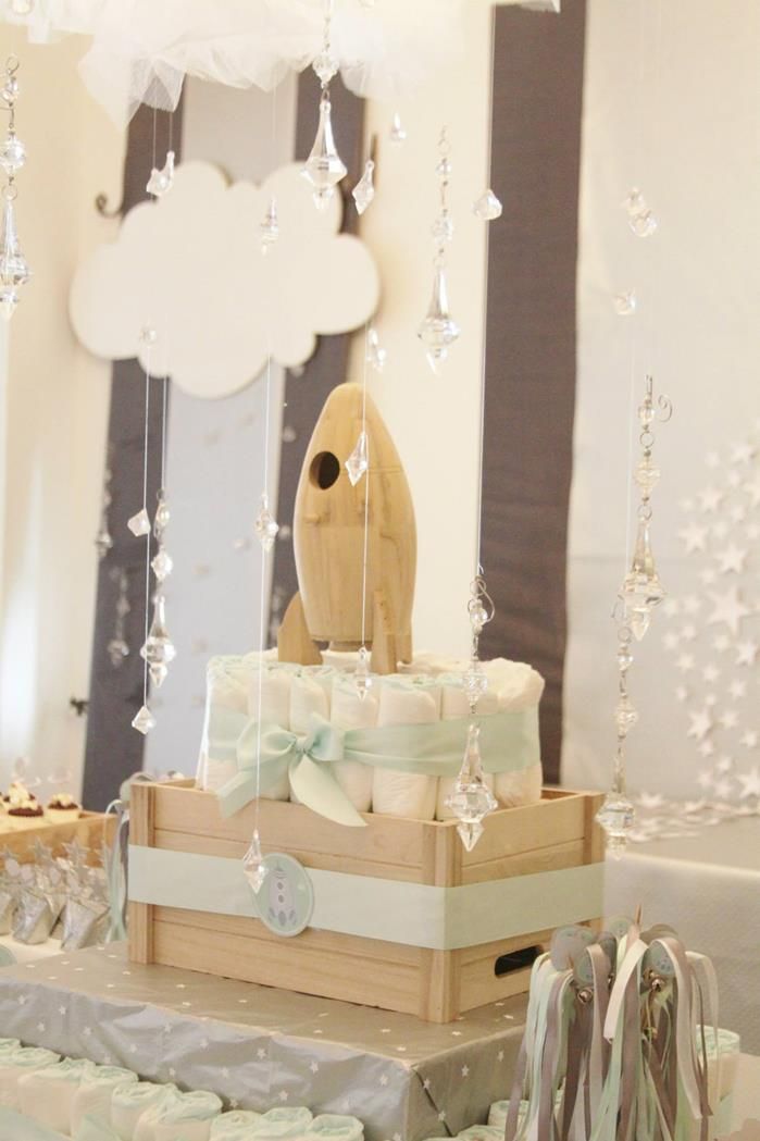 a baby's diaper cake sitting on top of a table next to other items