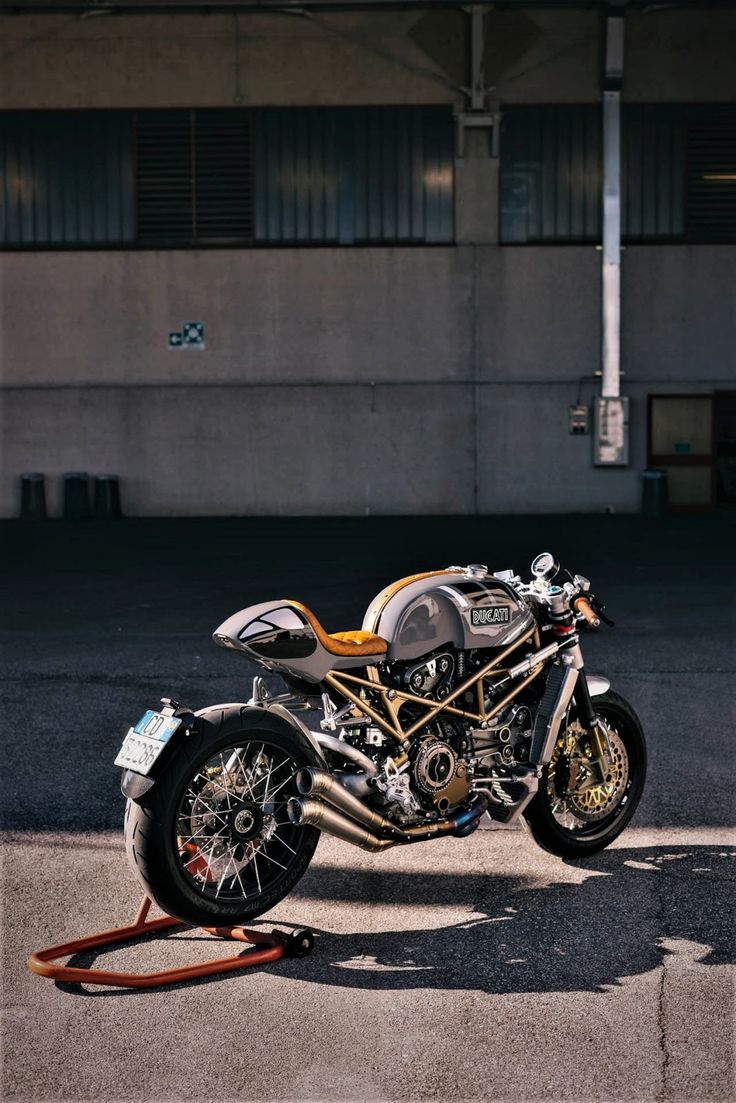 a motorcycle parked in front of a building with no one on it's bike