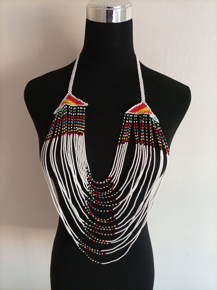 African wedding necklace, Zulu necklace, Beaded shawl necklace, African jewelry, Masai necklace, Bridesmaid necklace, Wedding gift This stunning necklace is superbly crafted with fine beads. The necklace can be worn with any outfit at different occasions and it will absolutely make you stand out. 100% handmade using fine beads. Closure: ball joint Color: White. 3-5 days delivery via DHL Express The shipping fee is for the first item only and additional necklaces or items ship for free. Wholesale Traditional White Beaded Necklaces For Festivals, Traditional White Beaded Necklace For Festival, Bohemian Beaded Necklaces With Dangling Beads For Weddings, Bohemian Beaded Chain Necklace For Wedding, Bohemian Beaded Necklace With Dangling Beads For Wedding, Multicolor Beaded Chain Necklace For Wedding, Multicolor Polished Beads Necklace For Wedding, Multicolor Beaded Necklace For Wedding, Traditional Beaded Long Bridal Necklace