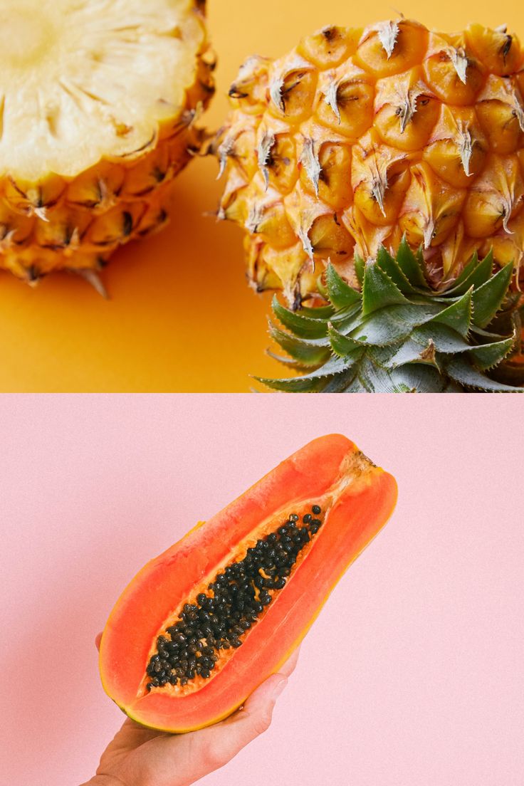 a hand holding a piece of fruit next to a pineapple on a pink and yellow background