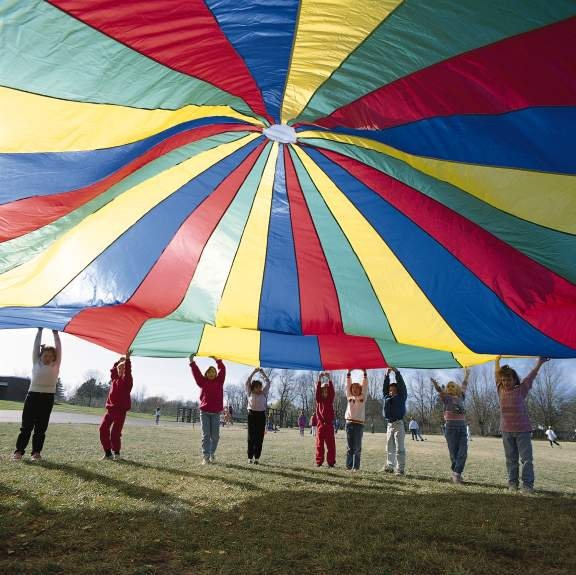 people holding up a large colorful kite in the air with caption that reads, pub crawl update the parachute is 1 of 8 events