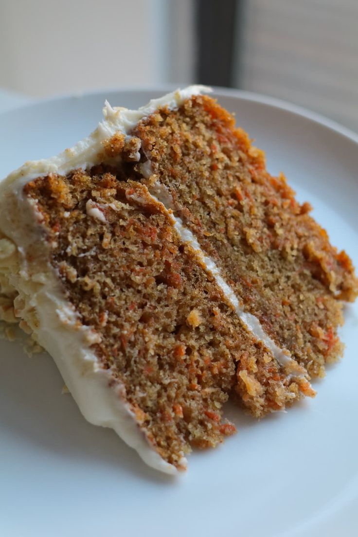 a slice of carrot cake on a white plate