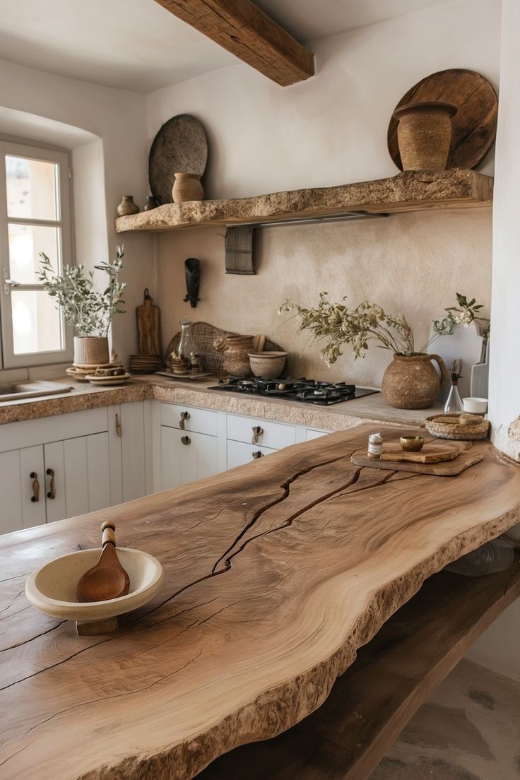 a wooden table sitting in the middle of a kitchen