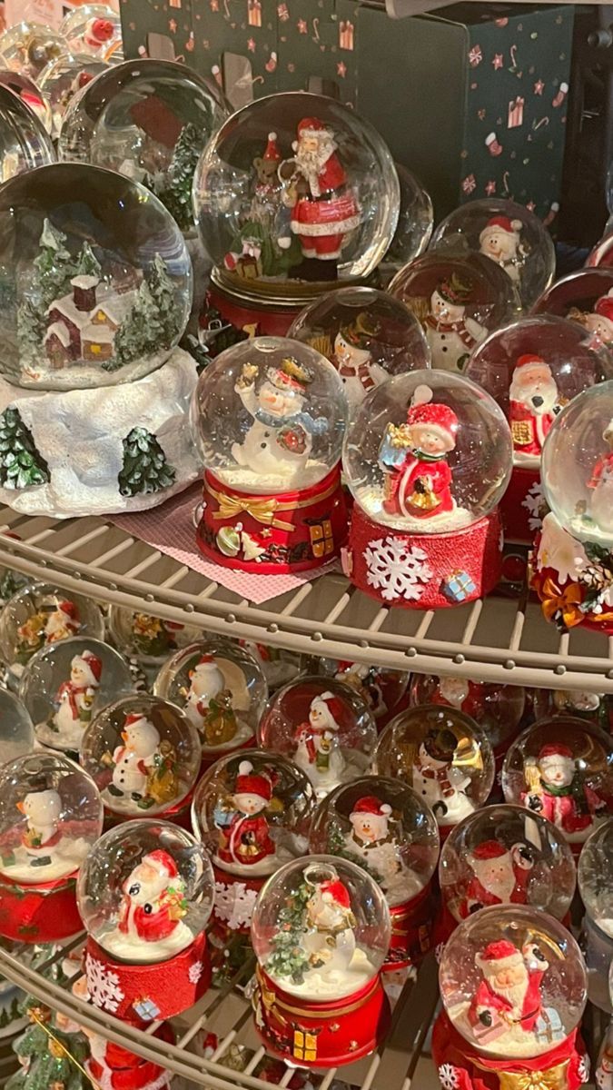 there are many snow globes on the shelves