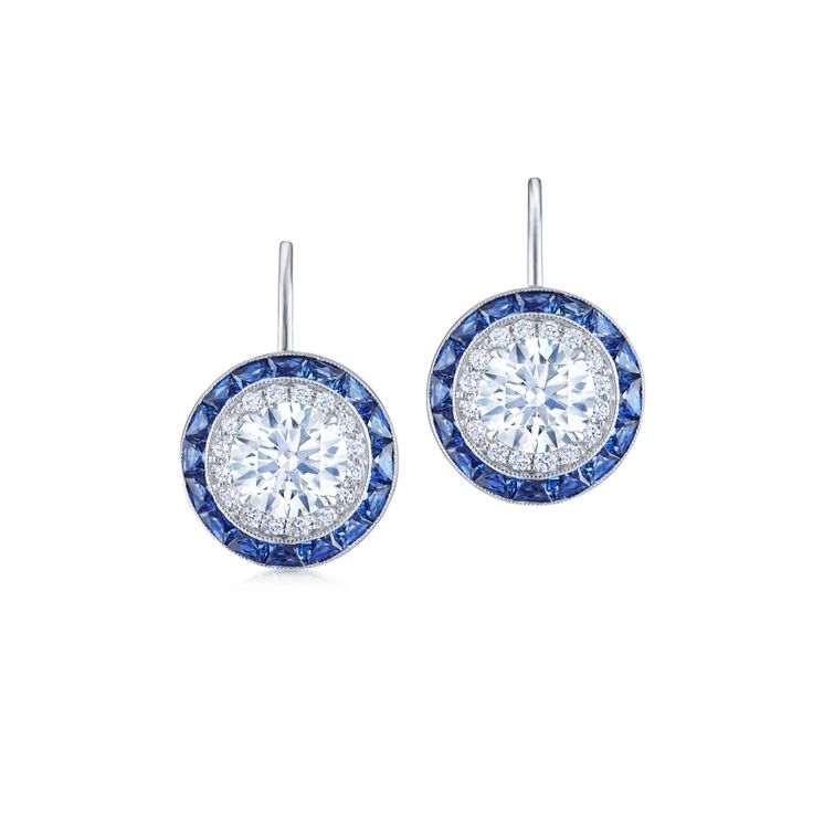 These drop earrings feature round brilliant diamonds bordered by double frames of diamonds and calibré cut sapphires. Diamond Earring Jackets, Silhouette Earring, Halo Diamond Earrings, Earrings With Diamonds, Diamond Earrings Studs Round, Buying An Engagement Ring, Earring Jackets, Diamond Earring, Shop Engagement Rings