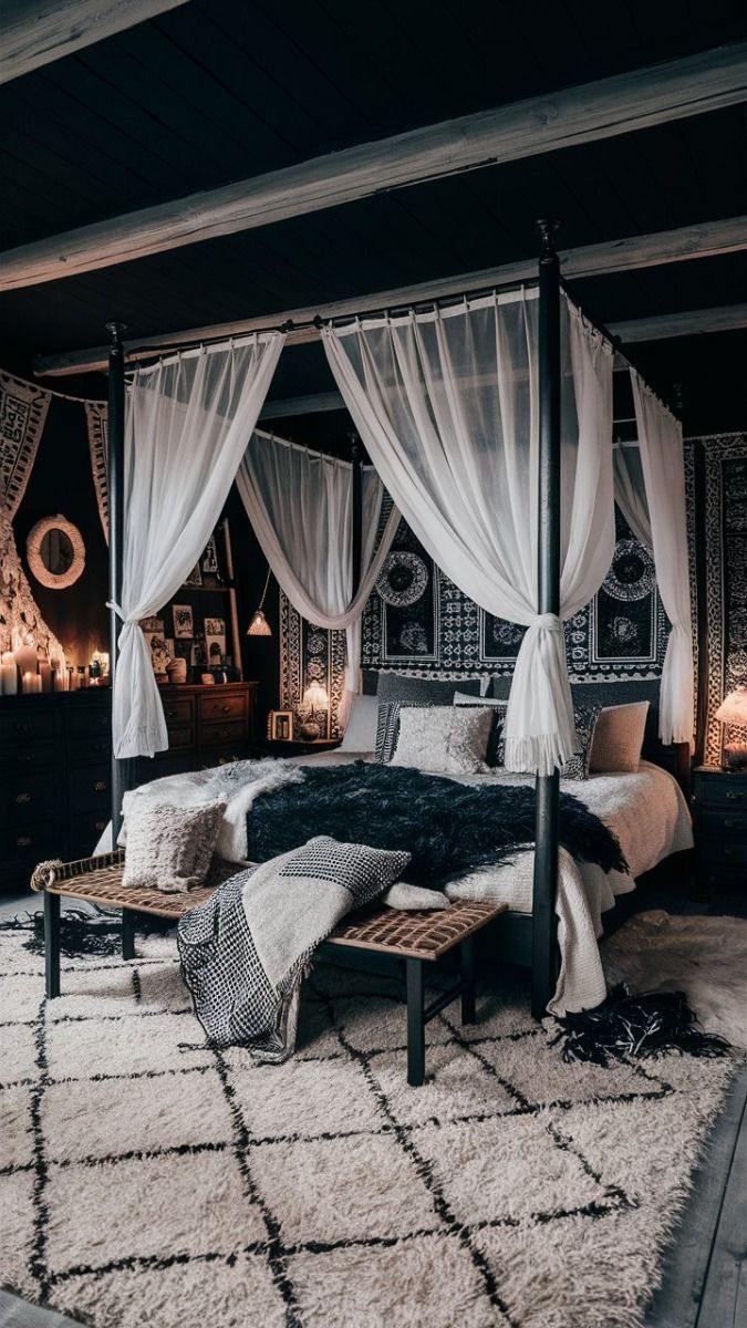 a bedroom with four poster bed and white drapes on the canopy over it's head