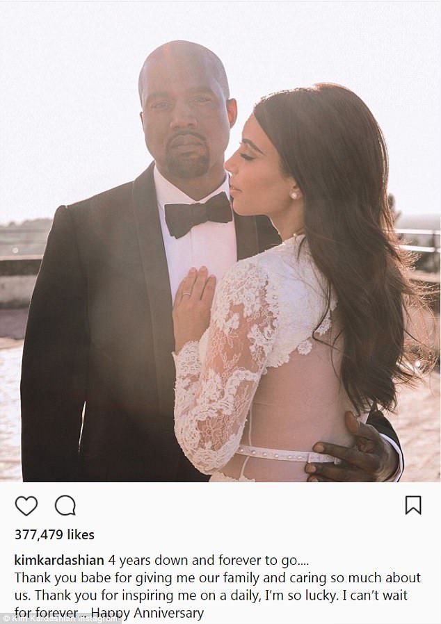 a man and woman standing next to each other in front of the ocean wearing tuxedos