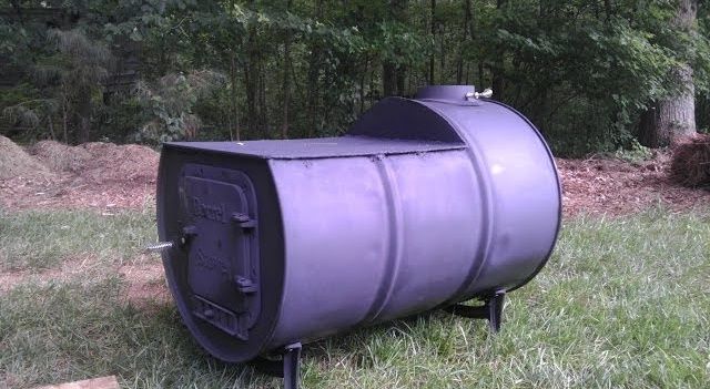 a large metal barrel sitting in the grass