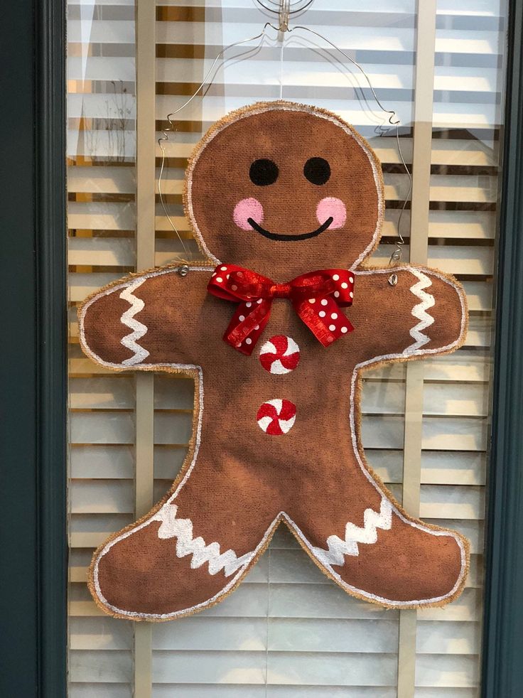 a gingerbread man is hanging on the window sill