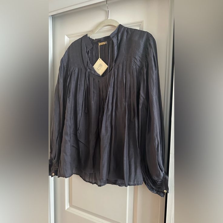 Gorgeous 100% Lyocell Otherwise Known As Tencel Which Is A Sustainable Man Made Fabric Very Closely Resembling Silk. There Is A Very Slight Sheen But More Matte Close Up. Hard To Photograph. Very Breathable. A Beautiful Gun Metal Grey Color. It A Flowy Poet Style Shirt. Great W Skinny Jeans And Heels Or Tucked In To High Waisted Pants. Gorgeous! Chic Tencel Tops For Spring, Chic Tencel Tops, Spring Long Sleeve Tencel Tops, Tencel Blouse For Workwear, Summer Tencel Blouse For Workwear, Tencel Workwear Blouse, Grey Silk Blouse, Floral Ruffle Top, Yellow Blouse