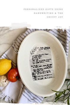 a white bowl sitting on top of a table next to some vegetables and lemons