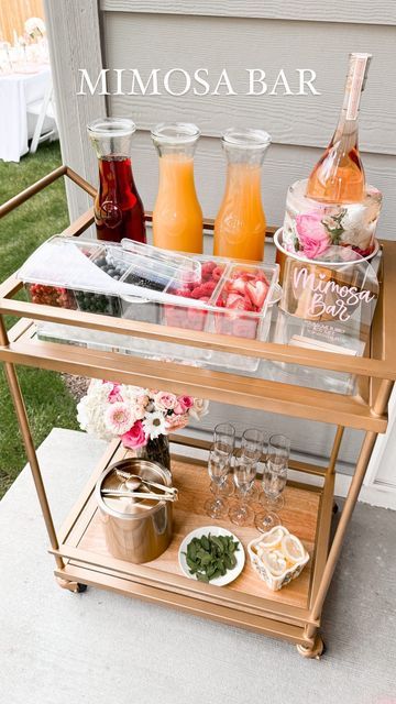 a bar cart filled with drinks and condiments on the side of a house