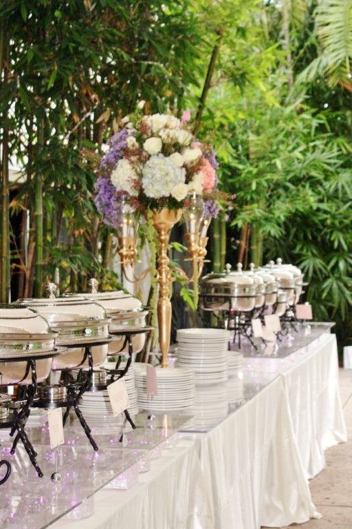 a table topped with lots of white and purple plates