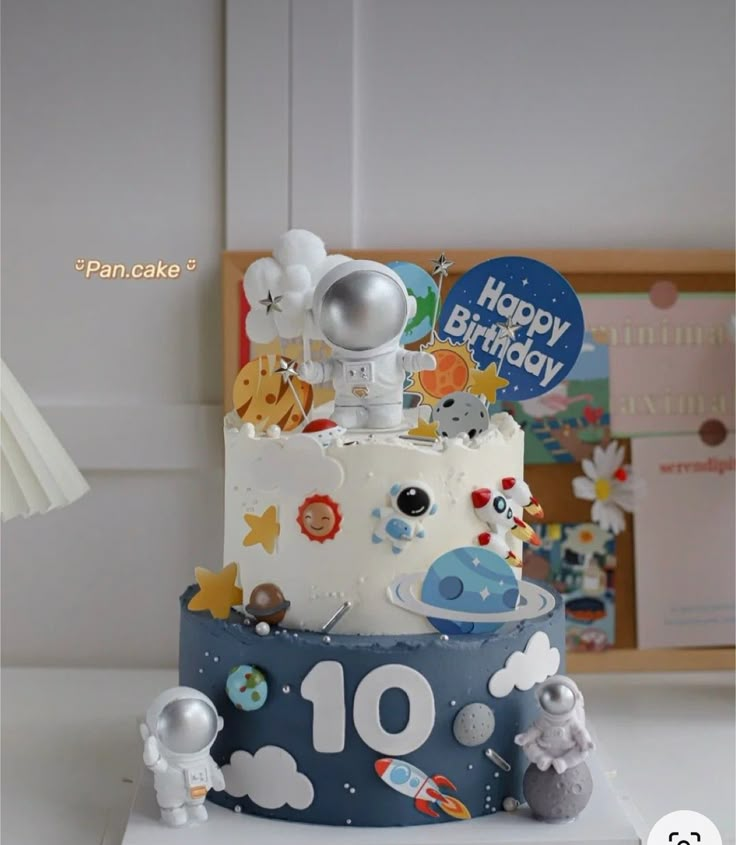 a birthday cake with an astronaut theme on it