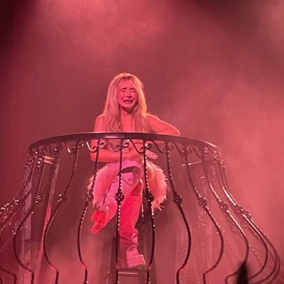 a woman sitting on top of a metal structure