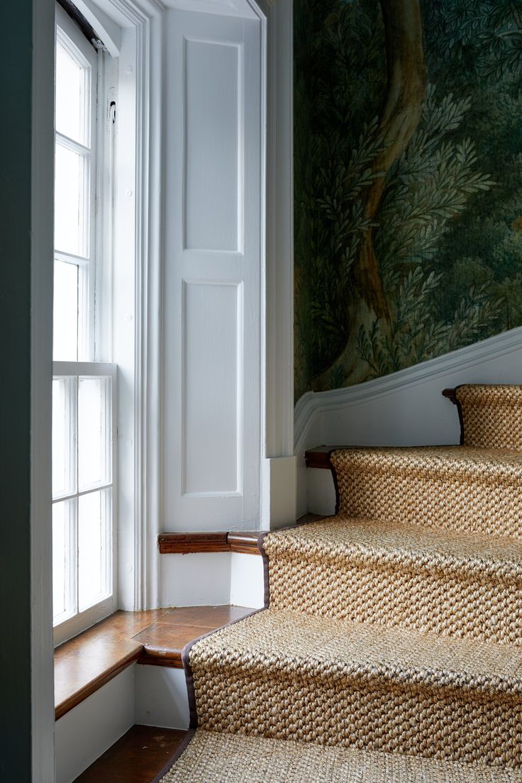 an image of some stairs going up to the room that is decorated with wallpaper