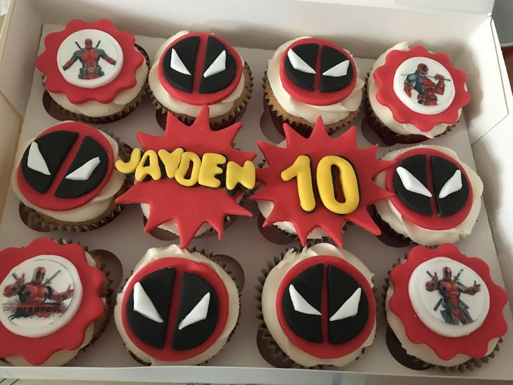 the cupcakes are decorated with fondant spider - man and deadpool characters