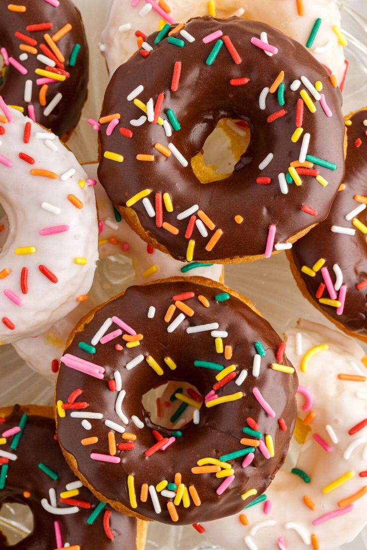 there are many donuts with chocolate frosting and sprinkles