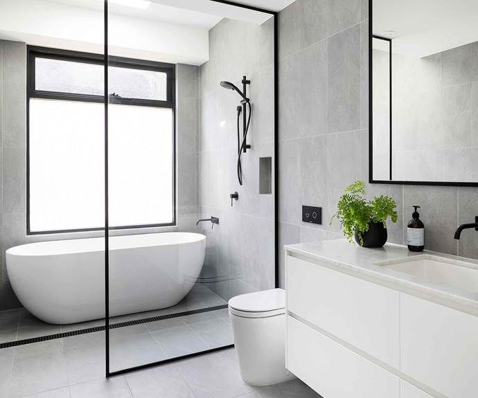 a bathroom with a tub, toilet and sink in it's center piece is shown