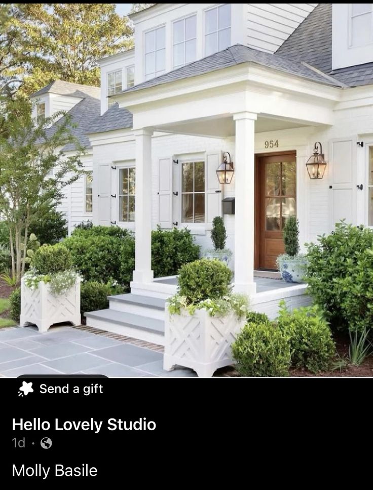 a house with white trim and windows on the front porch is featured in this postcard