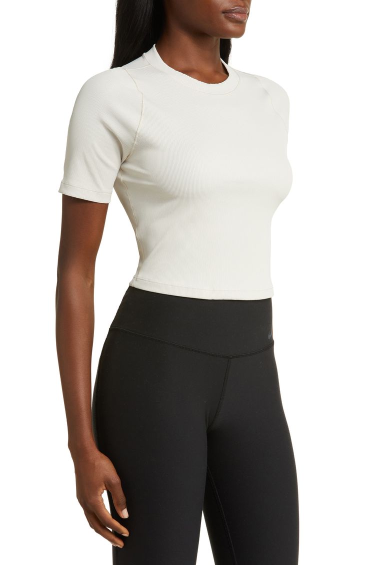 Narrow ribbing adds subtle texture to a slightly cropped top that's ready to elevate your casual look. 17" length (size Medium) 18 1/2" length (size XX-Large) Crewneck Short sleeves InfinaSoft lightweight fabric 78% nylon, 22% spandex Machine wash, tumble dry Imported Versatile Medium Support Crop Top, Nike Cropped Activewear, Sporty Everyday Crop Top, Cropped Athleisure Top With Minimal Stretch, Ribbed Crew Neck Top With Minimal Stretch, Relaxed Fit Solid Top With Ribbed Waistband, Solid Relaxed Fit Top With Ribbed Waistband, Relaxed Fit Top With Ribbed Waistband, Versatile Ribbed Crop Top