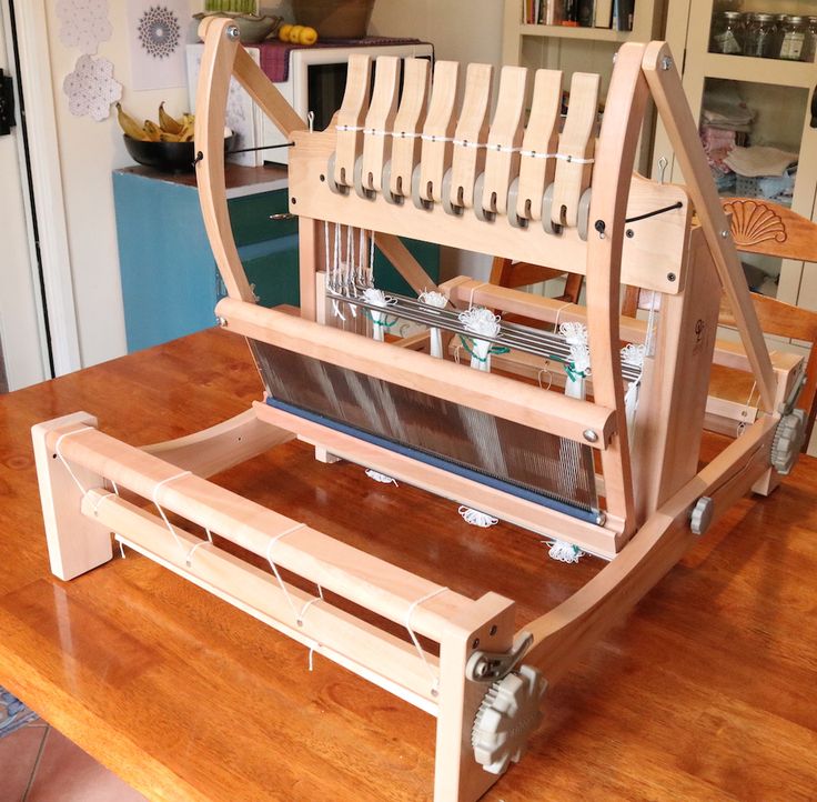 a wooden loom sitting on top of a table